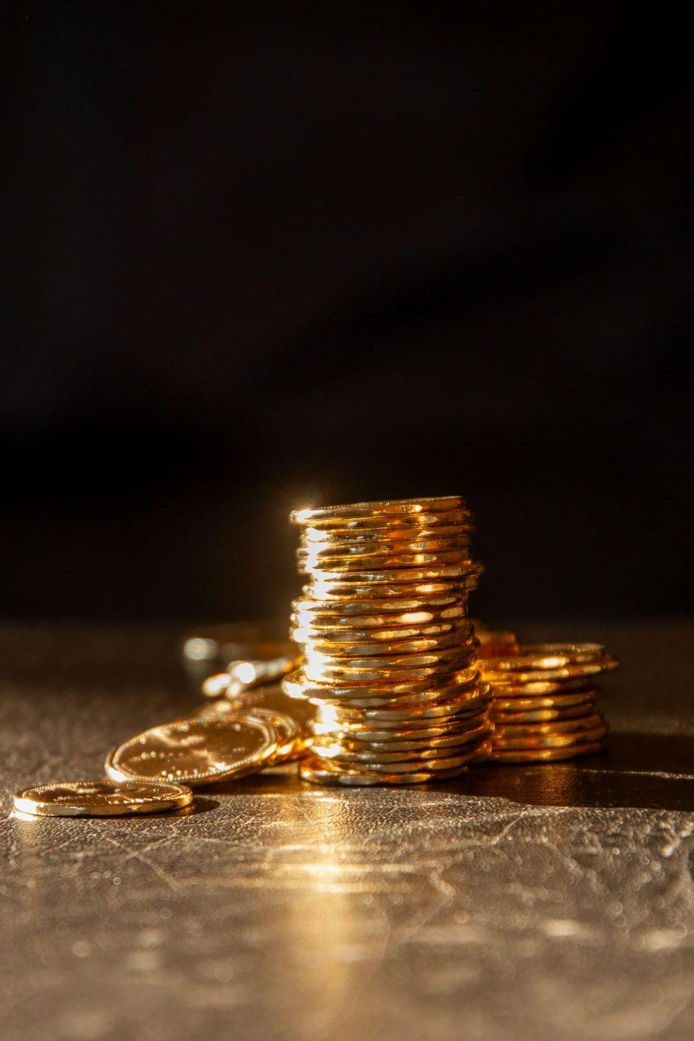 A pair of hands holding a fine gold piece in soft light